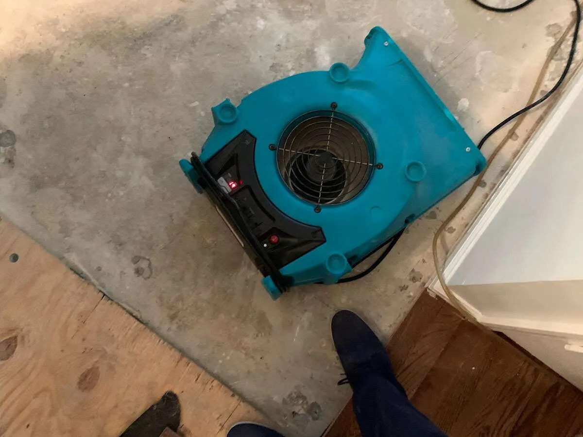 Air mover drying subfloor during Leak Detection & Repair in Durham